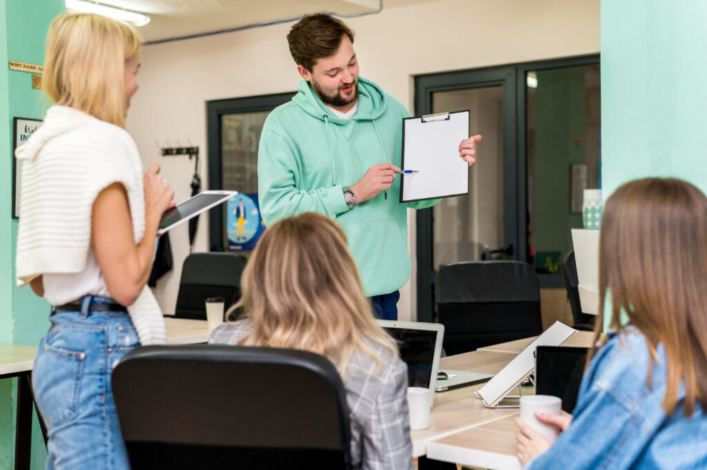 Teaching Assistant student helping learners during a classroom lesson at Apex Community College.