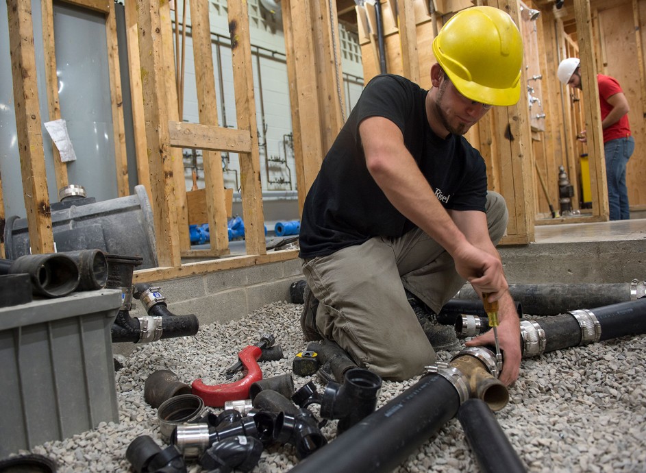studentPlumber gaining hands-on experience in plumbing techniques and practical trade training at Apex Community College.