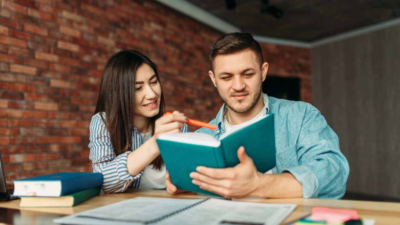 university-students-reading-textbook-together.jpg